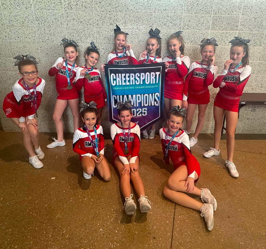 Iowa Ambush competition team holding the 2025 CheerSport Champions banner